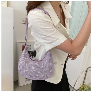 Detail of lavender crescent bag with silver rhinestones on model's shoulder