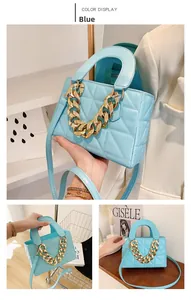 Detail view of light blue quilted tote bag with chunky gold chain and macaron finish
