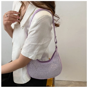 Detail view of purple crescent rhinestone shoulder bag on model with silver chain