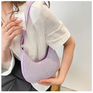 Close-up of lavender crescent underarm bag with shimmering rhinestones and chain detail