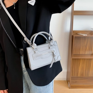 Minimalist light grey structural tote bag with top handle and shoulder strap for women