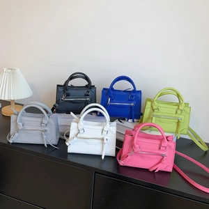 Chic trapezoid handbags in six colors with decorative tassels and detachable straps