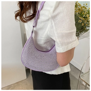 Detail showing a purple crescent underarm bag with sparkling rhinestones on the surface