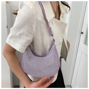Detail of purple hobo bag with sparkling rhinestones worn by model on shoulder