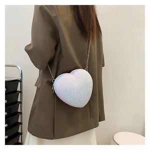 Detailed back view of a heart-shaped sequin crossbody bag with gold chain strap