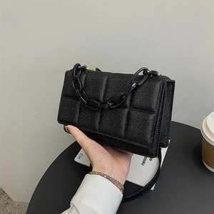 Minimalist black quilted shoulder bag with chunky chain strap for a stylish urban look