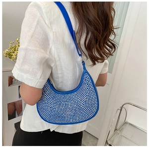 Detail of Klein blue crescent underarm bag featuring shimmering silver rhinestones and chain