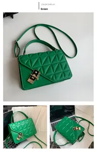 Detail showing green quilted faux leather handbag with black gold metal lock and chain