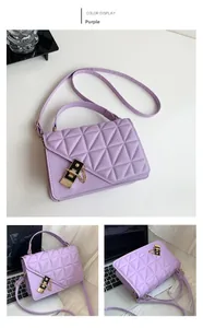 Detailed view of a purple quilted shoulder bag featuring geometric triangle patterns and a lock