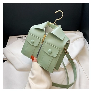 Detail of mint green jacket-shaped crossbody bag featuring collar and zipper details