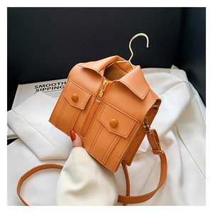 Detail of creative orange jacket-shaped crossbody bag with lapels and zipper