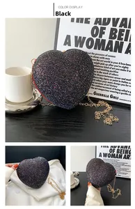 Detail of black heart-shaped evening bag with colorful sequins and golden chain strap