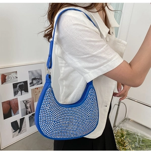 Detail of blue crescent underarm bag with sparkling rhinestones and adjustable strap