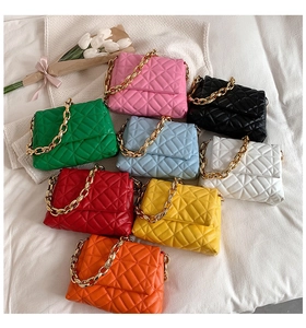 Flat lay of quilted PU shoulder bags with acrylic chains in eight vibrant colors