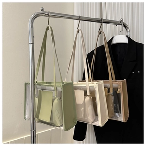 Detailed view of PVC transparent tote bags in green, cream, and khaki with inner pouches