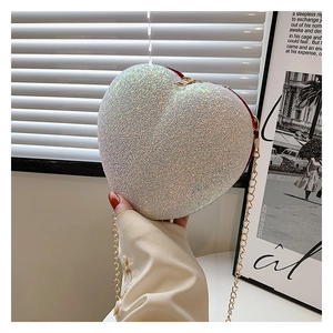 Detail of heart-shaped glitter purse featuring high-density sequins and gold chain strap
