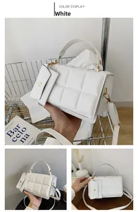 Detail of white quilted crossbody bag with matching coin purse and gold chain hardware