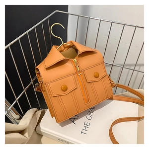 Detailed close-up of a creative yellow jacket-shaped crossbody bag with metal zippers