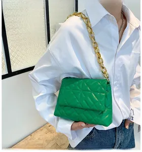Detail view of green quilted PU shoulder bag with thick gold acrylic chain strap