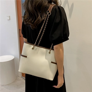 Chic beige and brown tote bag with gold chain strap for stylish daily commuting wear