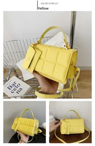 Detailed view of yellow quilted handbag with matching mini coin purse and detachable strap