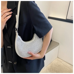 Detail of white crescent bag with silver rhinestones and adjustable leather strap