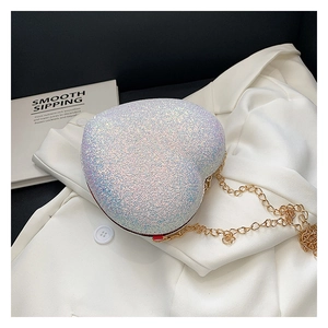 Detail shot of heart-shaped sequin bag with iridescent glitter and gold chain strap