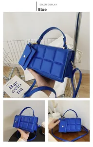 Detailed view of Klein Blue quilted square handbag with matching coin purse and gold hardware