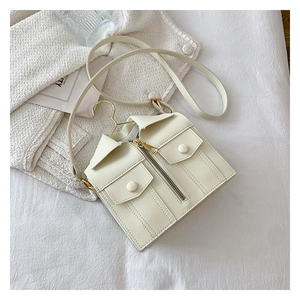 Detailed view of creative cream-white shirt shaped crossbody bag with collar and buttons
