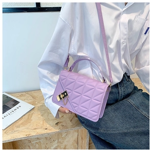 Detail of lavender quilted rectangular crossbody bag with gold twist lock and chain