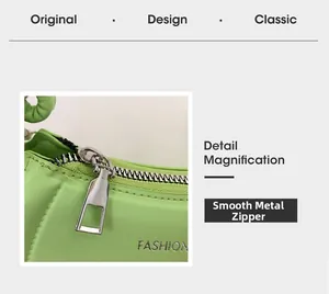 Detail magnification of smooth silver metal zipper on bright green fashion handbag