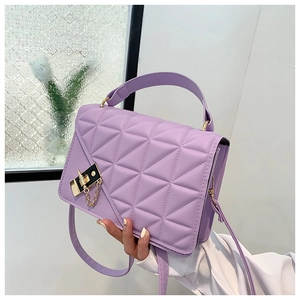 Detail showing lavender quilted PU leather surface with gold chain and metal twist lock