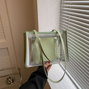 Transparent PVC tote bag with mint green trim and inner pouch shown in use