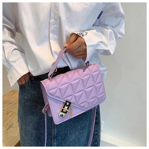Detail of lavender quilted shoulder bag with gold hardware and triangular pattern