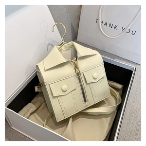 Detailed view of cream-white jacket-shaped crossbody bag with gold hook and zipper details