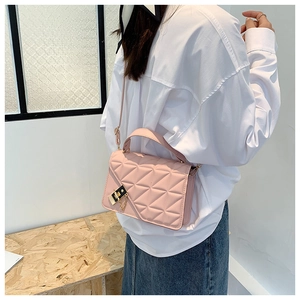 Pink quilted PU leather handbag featuring a rotating metal lock and elegant top handle