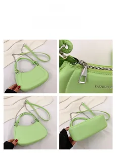 Detail view of apple green half moon bag with chain strap and knot handle accents
