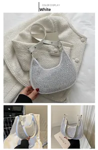 Detailed view of white rhinestone baguette bag with sparkling finish and chain strap