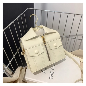 Detail view of a cream white PU leather jacket-shaped crossbody bag with gold hardware