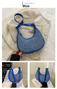 Detail of blue hobo bag with silver stud accents and adjustable shoulder strap