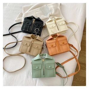 Flat lay of mini jacket-shaped crossbody bags in black, beige, and pastel colors