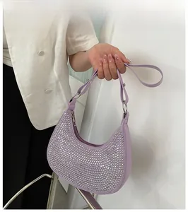 Detail of light purple crescent bag with silver rhinestones and metal buckles