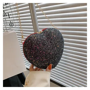 Detail of glitter heart bag with black sequins, gold chain and red edge trim