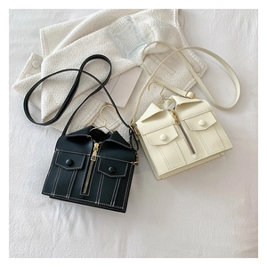 Unique jacket-shaped shoulder bags with gold hanger handles in black and cream PU leather