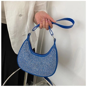 Detail view of royal blue underarm bag with shimmering silver rhinestones and chain