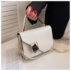Close-up of white leather handbag with gold-rimmed diamond clasp and chain strap