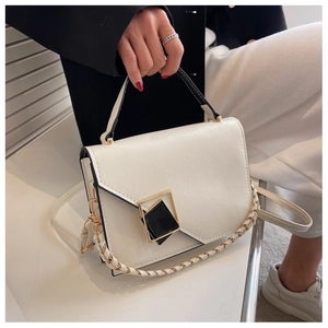 Close-up of minimalist white PU leather handbag with geometric black and gold buckle