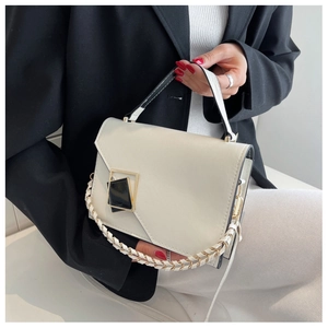 Detail of off-white structured handbag with geometric buckle and woven chain strap