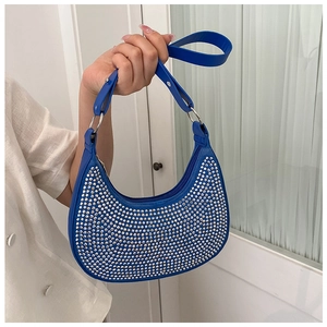 Detail of royal blue hobo bag with sparkling silver rhinestones and adjustable strap