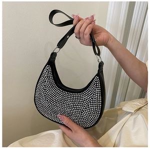 Detail of hobo bag with dense silver rhinestones and black leather shoulder strap
